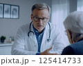 A doctor is engaged in a conversation with a patient in a hospital setting 125414733