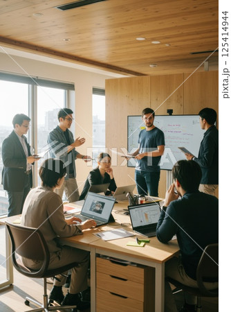 デバイスを活用して協働する日本人チームのモダンオフィス（ai生成画像） 125414944