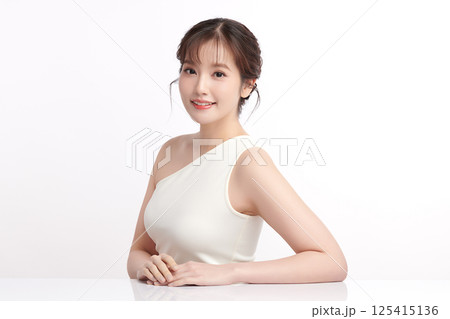 A beautiful young Asian woman with clean, fresh skin against a white background. Skincare, facial treatment, cosmetology, beauty, and spa. An elegant portrait of an Asian woman. A beautiful young Asian woman with clean, fresh skin against a white background. Skincare, facial treatment, cosmetology, beauty, and spa. An elegant portrait of an Asian woman. 125415136