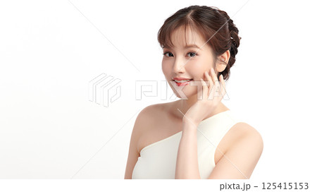 A beautiful young Asian woman with clean, fresh skin against a white background. Skincare, facial treatment, cosmetology, beauty, and spa. An elegant portrait of an Asian woman. A beautiful young Asian woman with clean, fresh skin against a white background. Skincare, facial treatment, cosmetology, beauty, and spa. An elegant portrait of an Asian woman. 125415153
