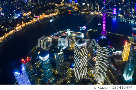 Shanghai, China - 1 April 2025: A stunning night view from Shanghai Tower, capturing the Oriental Pearl Tower, Huangpu River, Pudong district, and Shanghai World Financial Center 125416474