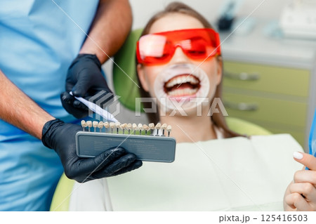 whitening procedure, Dentist starting teeth, receiving teeth cleaning, treating teeth, professional doctor fixing teeth, Dentist checking, patient dentist clinic whitening procedure, Dentist starting teeth, receiving teeth cleaning, treating teeth, professional doctor fixing teeth, Dentist checking, patient dentist clinic 125416503