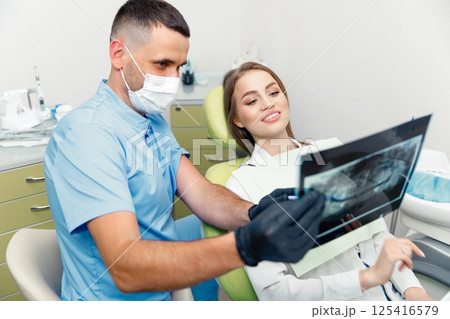 panoramic X-ray, dental consultation, dentistry clinic, dental inspection, dentist tells the patient, treating teeth, smiling patient panoramic X-ray, dental consultation, dentistry clinic, dental inspection, dentist tells the patient, treating teeth, smiling patient 125416579