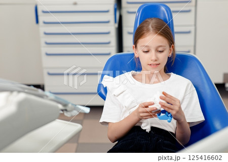 treatment teeth, Portrait child dentist, dental care, Dental treatment, Little girl visiting dentist, small child, dental clinic appointment treatment teeth, Portrait child dentist, dental care, Dental treatment, Little girl visiting dentist, small child, dental clinic appointment 125416602