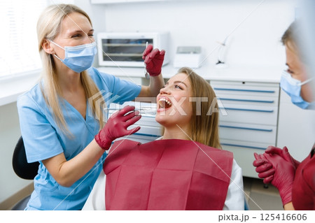 teeth whitening, dentist checking teeth, dental examination, patient's teeth, hospital office, ensuring dental health 125416606