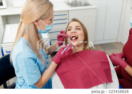 teeth whitening, dentist checking teeth, dental examination, patient's teeth, hospital office, ensuring dental health teeth whitening, dentist checking teeth, dental examination, patient's teeth, hospital office, ensuring dental health 125416626