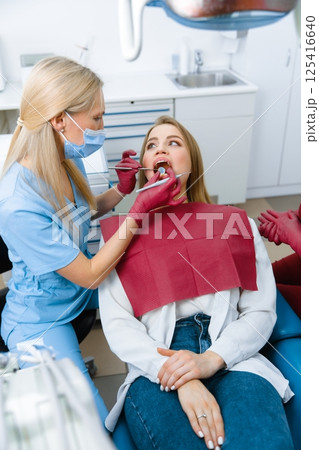 dentist examining, dentist examine tooth, dental instruments, examination patient, checking teeth, dentist showing, professional doctor fixing teeth, healthy smile 125416640