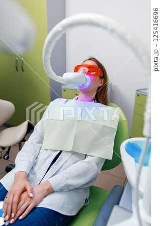 teeth whitening, Dentist starting teeth, whitening procedure, white teeth, receiving teeth cleaning teeth whitening, Dentist starting teeth, whitening procedure, white teeth, receiving teeth cleaning 125416696
