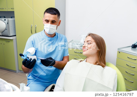 Dental treatment, Dentist checking teeth, dental examination, smiling woman, dental procedure, treating teeth, female at a dental clinic smiling 125416797