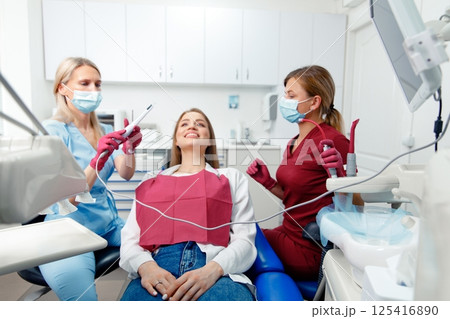 dental procedure, patient lying, dentist checking teeth, smiling patient, hospital office, oral care, dental health 125416890
