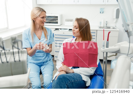 teeth whitening, dentist checking teeth, dental examination, patient's teeth, hospital office, ensuring dental health teeth whitening, dentist checking teeth, dental examination, patient's teeth, hospital office, ensuring dental health 125416940