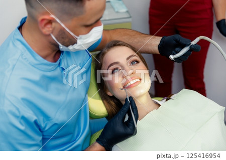 dental procedure, dentist chair, Dental treatment, smiling patient, female patient, Dentist examining, treating teeth, dental procedure, dentist chair, Dental treatment, smiling patient, female patient, Dentist examining, treating teeth, 125416954
