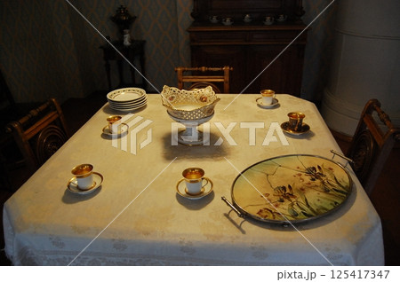 Elegant Vintage Dining Table with Fine Porcelain 125417347