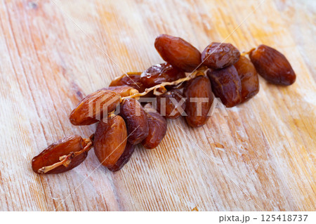 Tasty dried date on wooden table close up, mediterranean fruit 125418737
