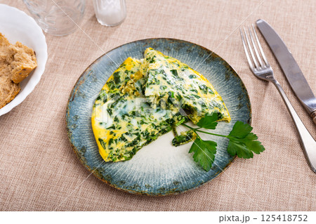 Appetizing breakfast omelette with spinach Appetizing breakfast omelette with spinach 125418752