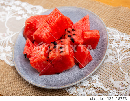 In plate there is small portion of watermelon pulp, useful cubes In plate there is small portion of watermelon pulp, useful cubes 125418778