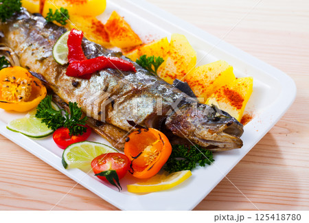 Baked trout with vegetables Baked trout with vegetables 125418780
