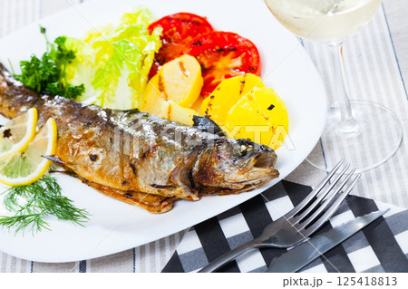 Baked trout with vegetables Baked trout with vegetables 125418813
