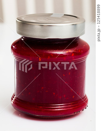 Raspberry jam in closed glass jar Raspberry jam in closed glass jar 125418899