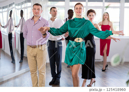 Men and women dancers standing in pairs in dance studio Men and women dancers standing in pairs in dance studio 125418960