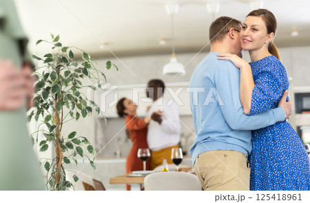 Men and women of different nationalities having fun dancing slow dance at house party 125418961