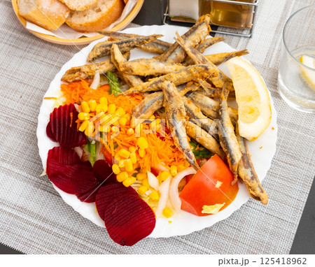 Dish with fried sardines, pilchards or anchovies in batter for traditional Spanish meal 125418962