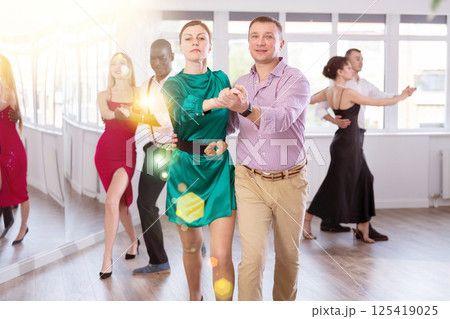 Man and woman dancing waltz in couple during lesson at studio Man and woman dancing waltz in couple during lesson at studio 125419025