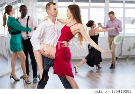 Young man and woman practicing tango in dancing studio Young man and woman practicing tango in dancing studio 125419092