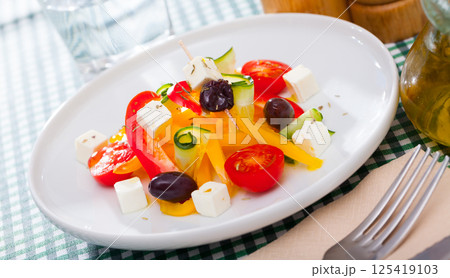 Delicious salad with tomatoes, cucumber, feta cheese and paprika Delicious salad with tomatoes, cucumber, feta cheese and paprika 125419103