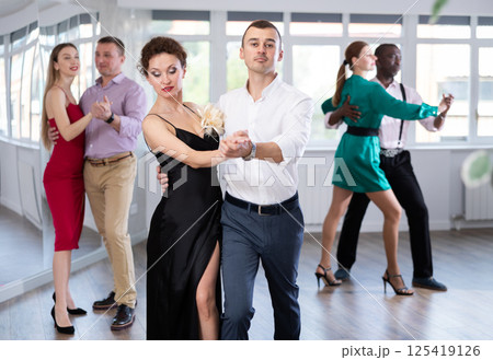 Man and woman dancing waltz in couple during lesson at studio Man and woman dancing waltz in couple during lesson at studio 125419126
