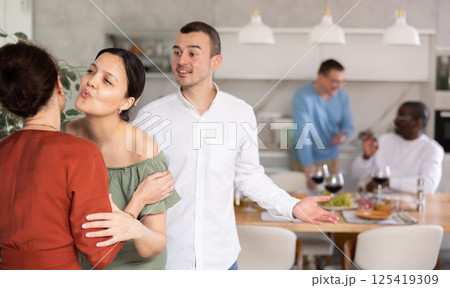 Two women greet each other when meeting 125419309