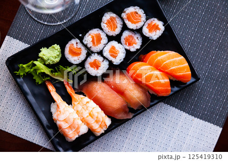 Various sushi served on black plate. Japanese food Various sushi served on black plate. Japanese food 125419310