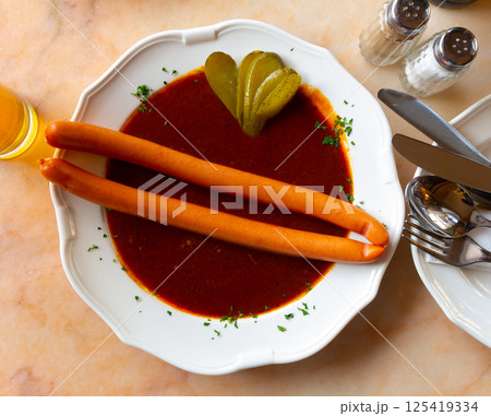 Two Viennese sausages with saftgoulash served on plate Two Viennese sausages with saftgoulash served on plate 125419334