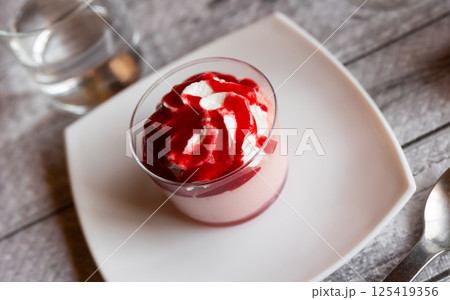 Sweet dessert raspberry mousse whipped to delicate foam is served in small bowl for breakfast. 125419356