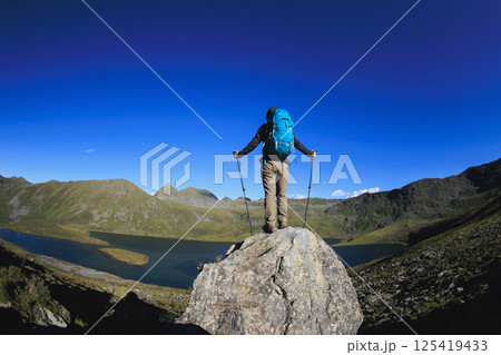 Backpacking woman on high altitude mountain top Backpacking woman on high altitude mountain top 125419433