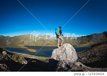 Hiking woman on high altitude mountain top Hiking woman on high altitude mountain top 125419434