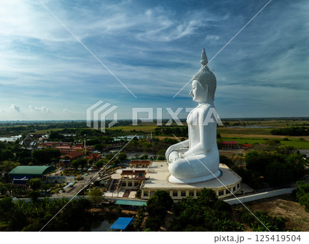 April 12, 2025,Massive white Buddha statue overlooking lush landscape in Ang Thong, Thailand during a clear day April 12, 2025,Massive white Buddha statue overlooking lush landscape in Ang Thong, Thailand during a clear day 125419504
