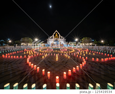 Lopburi, Thailand, April 12, 2025, Colorful lanterns illuminate the Puja celebration at Puttha Sathan Lopburi Sri Suvarnabhumi during the night. 125419534