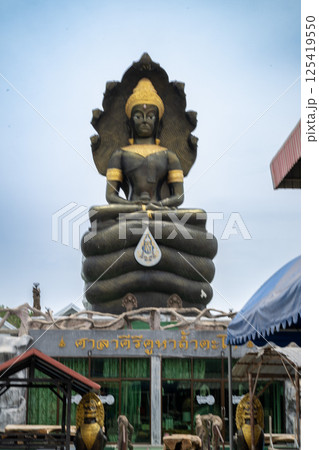 Lopburi, Thailand, April 14, 2025, Giant Buddha statue at Wat Tamtako, captivating visitors Lopburi, Thailand, April 14, 2025, Giant Buddha statue at Wat Tamtako, captivating visitors 125419550
