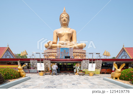 Singburi, Thailand, March 23, 2025, Golden Buddha statue at Wat Phikun Thong  attracting visitors 125419776