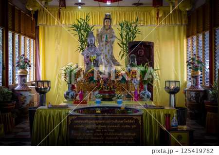 Singburi, Thailand, March 23, 2025, Wat Phra Non Chak Si Worawihan shrine, showcases colorful statues and offerings 125419782