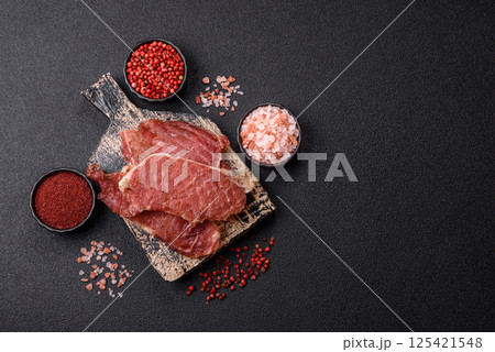 Jerky, dried pork meat slices with salt and spices 125421548