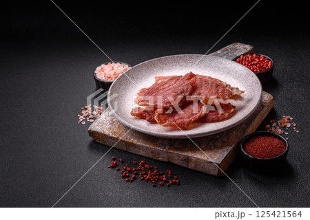 Jerky, dried pork meat slices with salt and spices 125421564