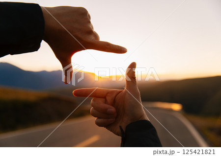 Hands in the shape of picture frame against the sunset Hands in the shape of picture frame against the sunset 125421821