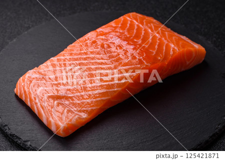 Fresh raw salmon steak with spices and herbs Fresh raw salmon steak with spices and herbs 125421871