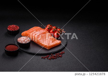 Fresh raw salmon steak with spices and herbs Fresh raw salmon steak with spices and herbs 125421878