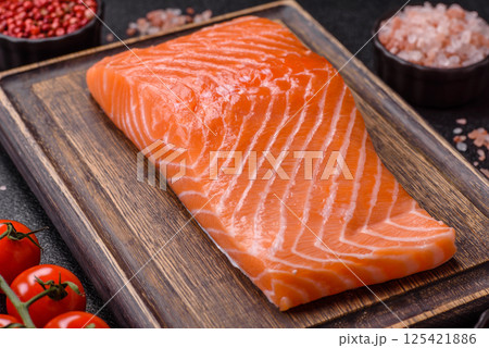 Fresh raw salmon steak with spices and herbs Fresh raw salmon steak with spices and herbs 125421886