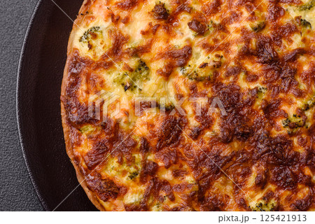 Delicious fresh quiche with broccoli, cheese, spices and herbs Delicious fresh quiche with broccoli, cheese, spices and herbs 125421913