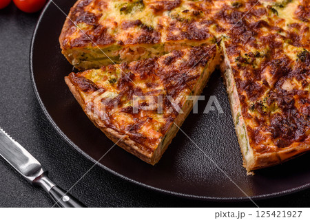 Delicious fresh quiche with broccoli, cheese, spices and herbs 125421927