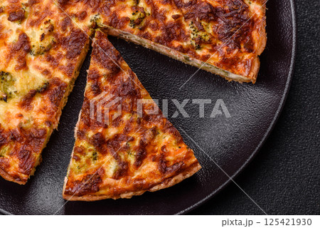 Delicious fresh quiche with broccoli, cheese, spices and herbs Delicious fresh quiche with broccoli, cheese, spices and herbs 125421930